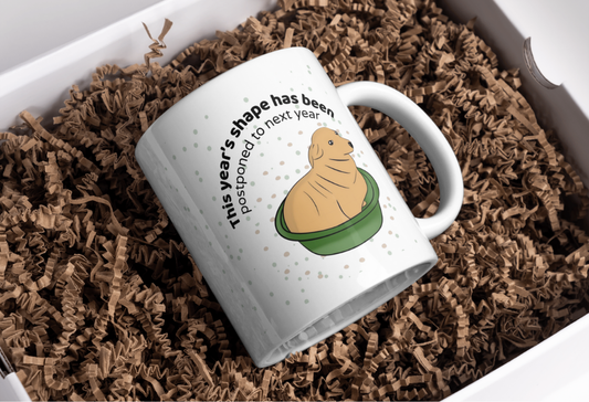 Funny Mug for Friends – “This Year’s Shape Has Been Postponed” Cup, Humor Coffee Mug, Lazy Workout Gift